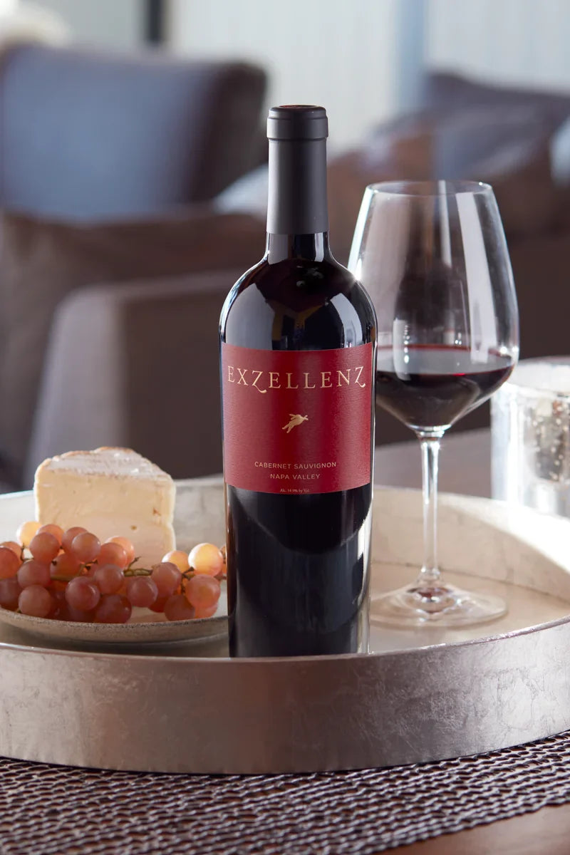 2019 HALL Exzellenz Cabernet Sauvignon on tray with cheese, fruit, and glass of red wine